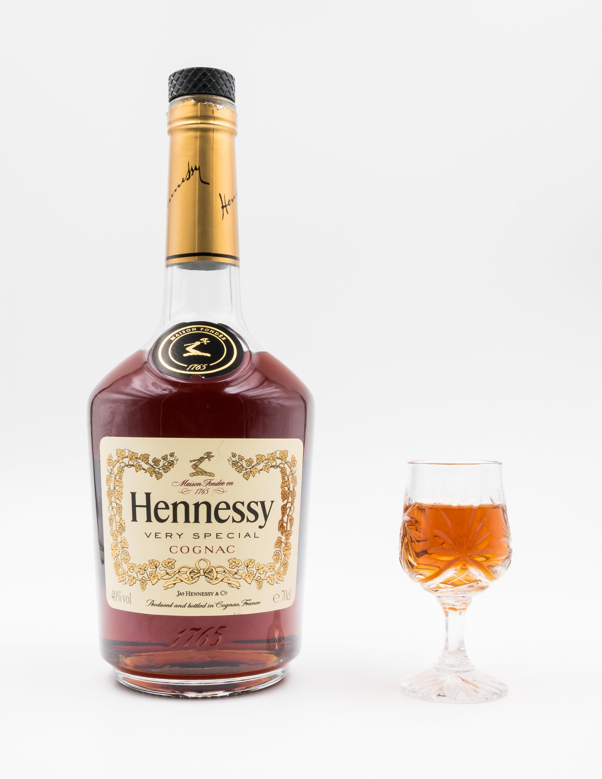 700 ml bottle of Hennessy Very Special cognac beside a glass