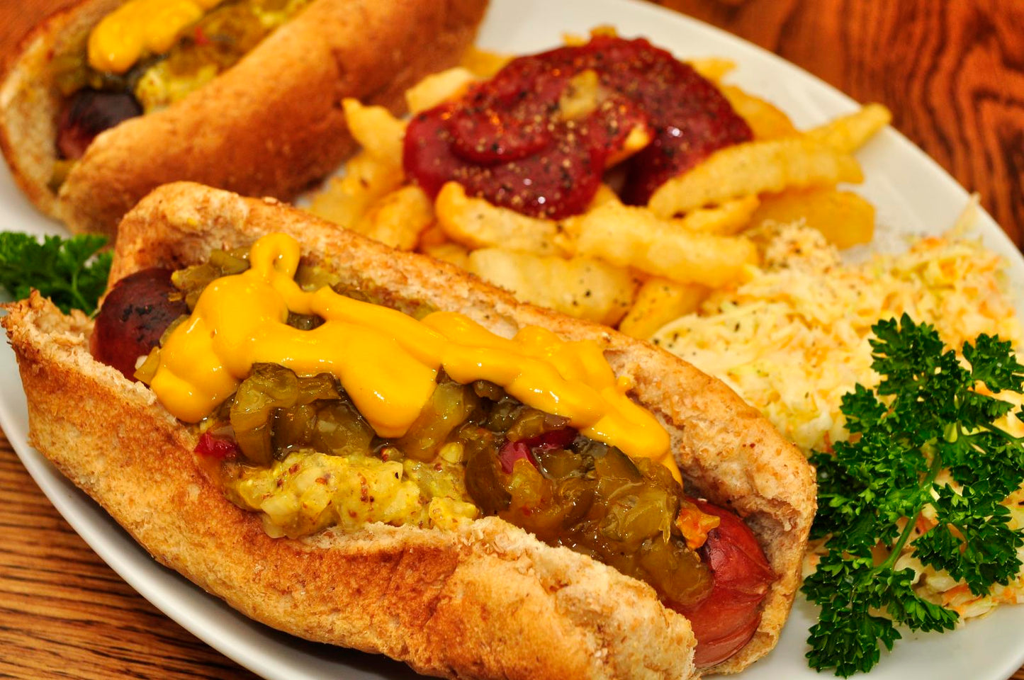 Hot dogs with mustard and relish served with fries and coleslaw