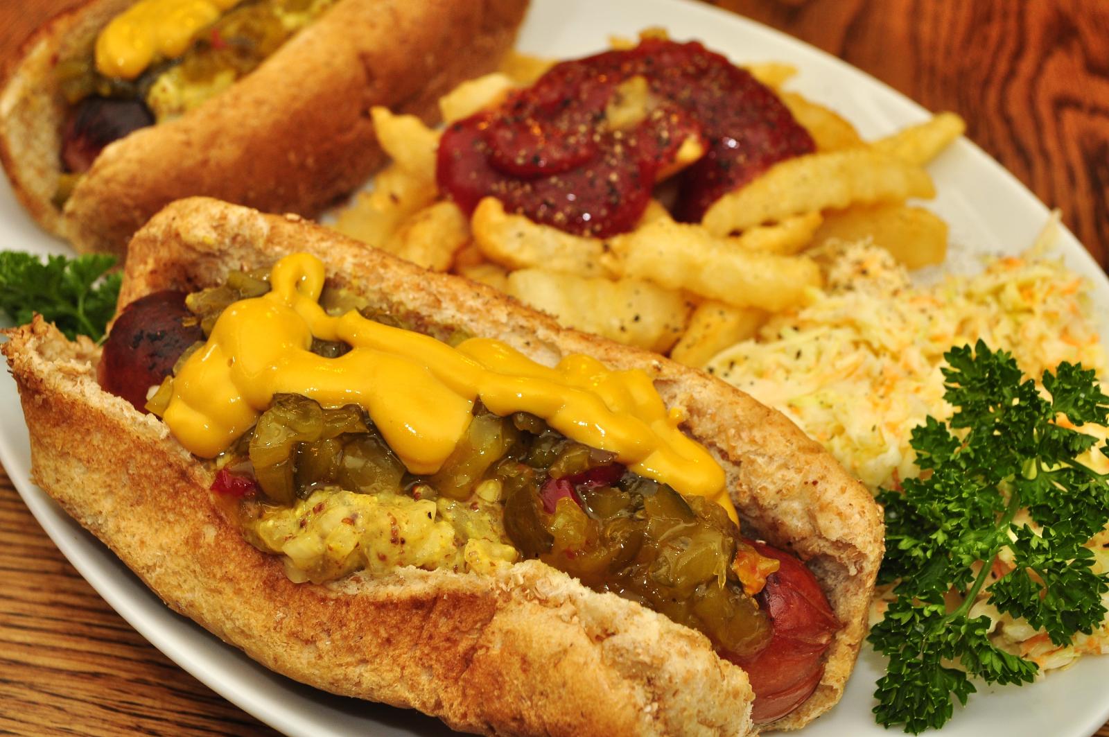 Hot dogs with mustard and relish served with fries and coleslaw