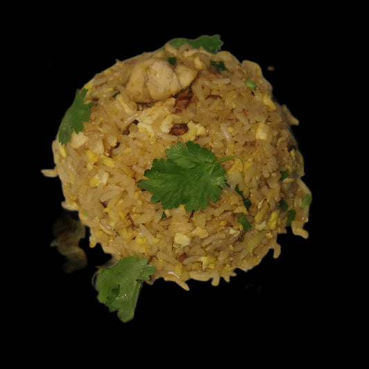Chicken fried rice plate on black background
