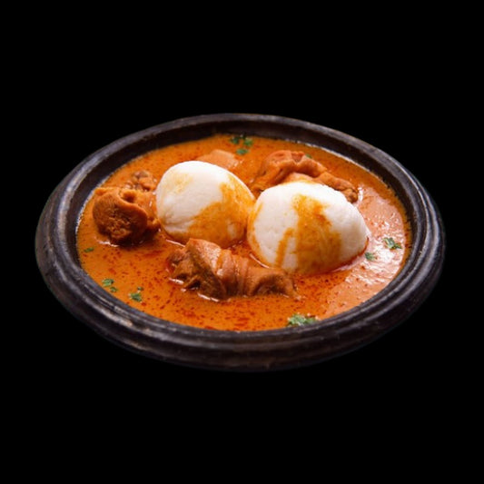 Omo tuo in groundnut soup on black background