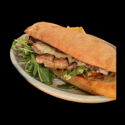 Suya steak sandwich on black background