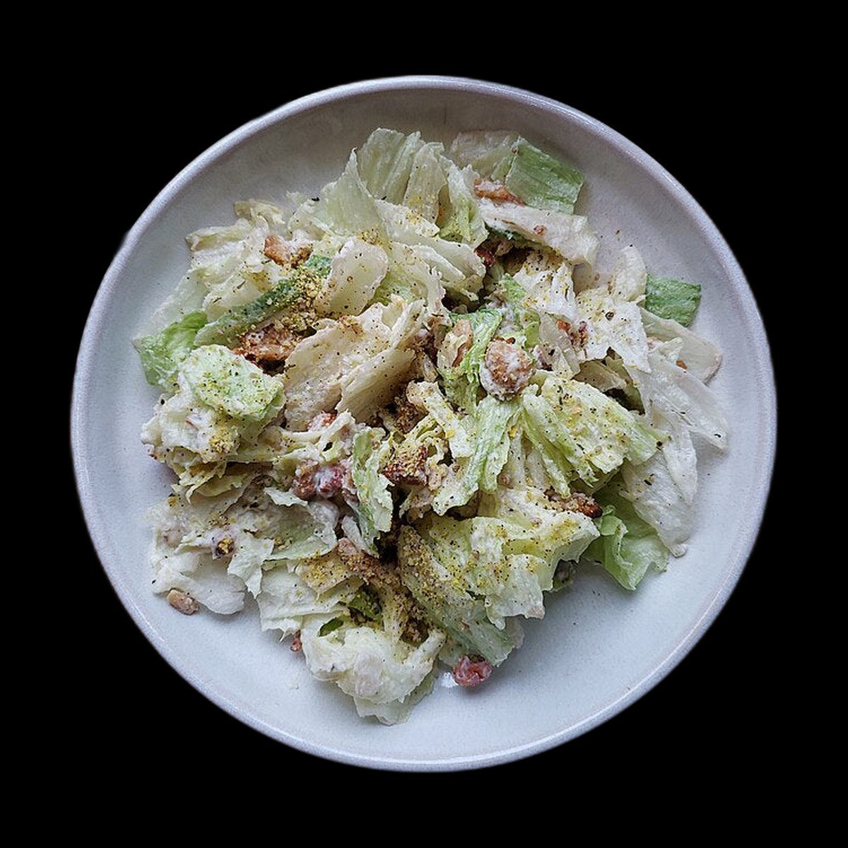 Caesar salad on black background