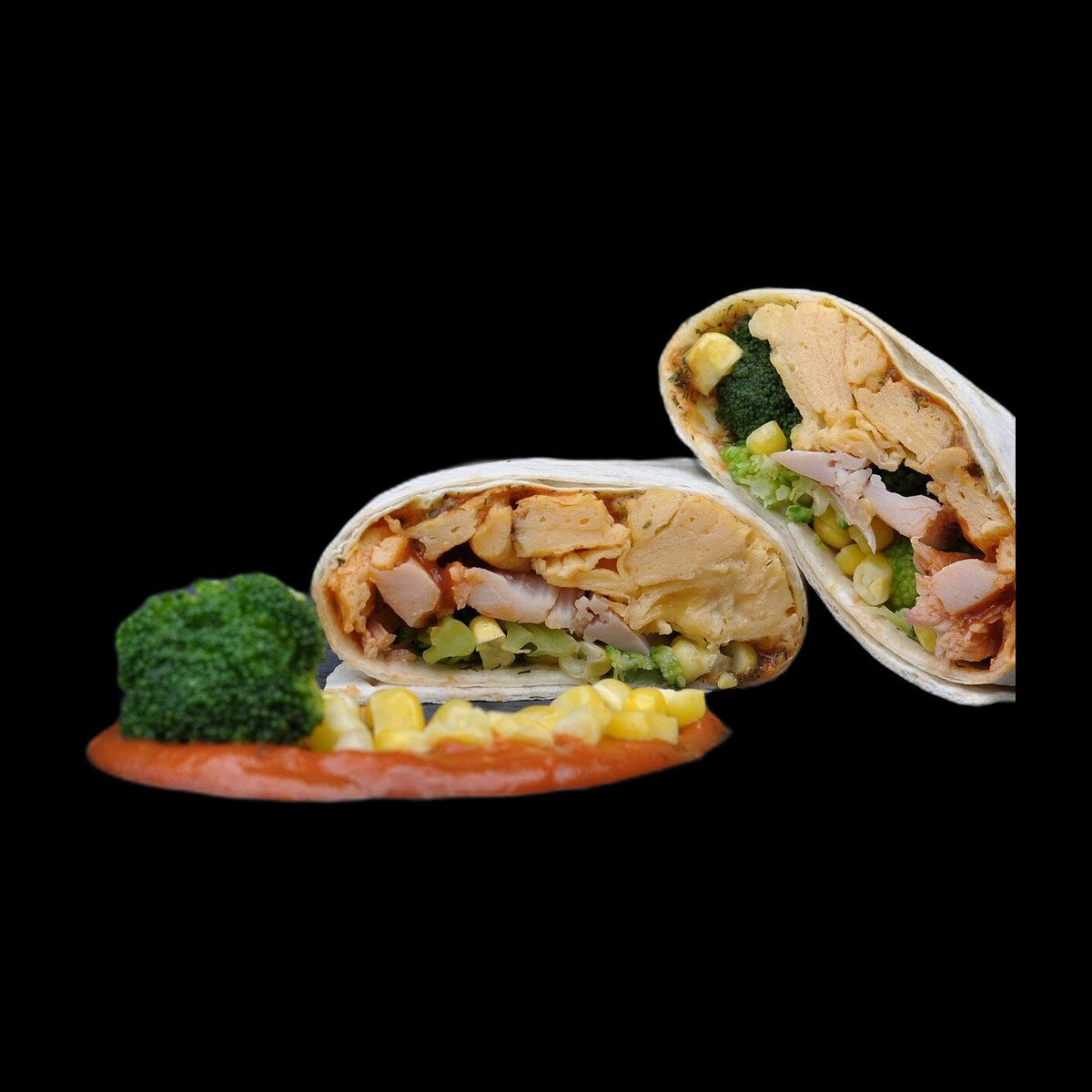 Chicken avocado wrap on black background