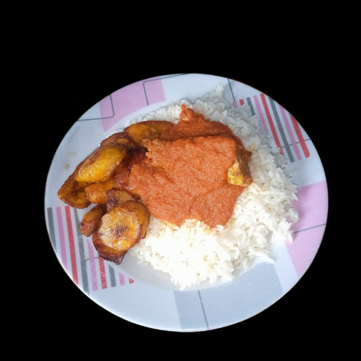 Rice and beans with plantain on black background