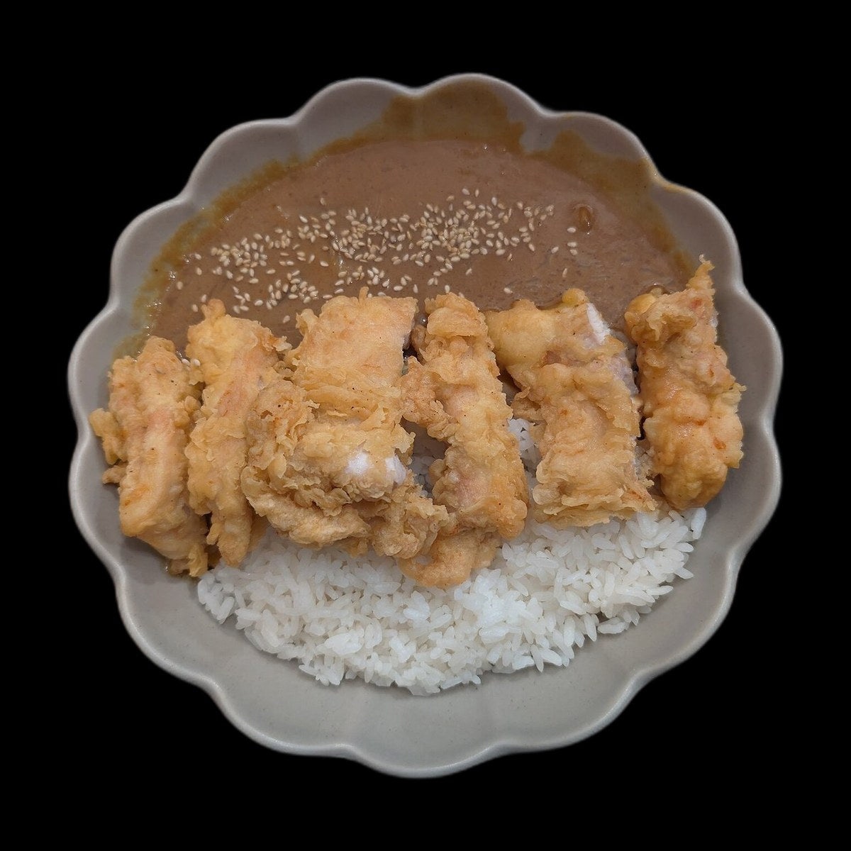 Chicken curry and rice on black background
