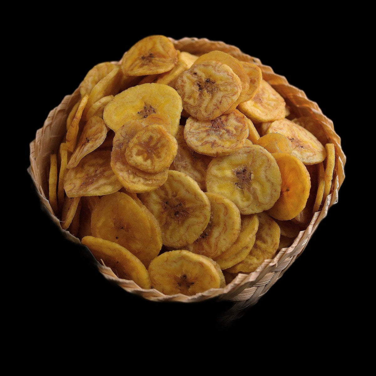 Plantain chips on black background